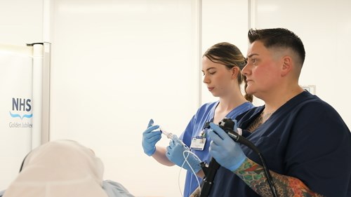 Two people interaciting with a device